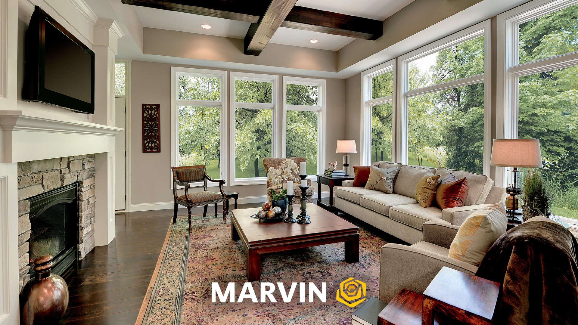Living room with wood beams and white trim windows